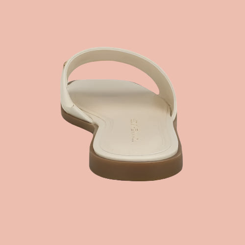 Beige sandal with a brown sole on a white background