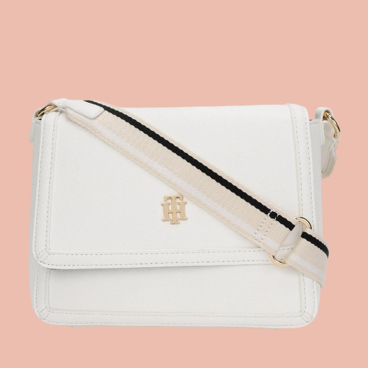 White crossbody bag with a strap on a light gray background