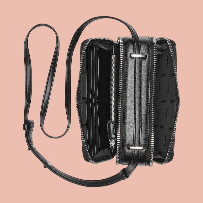 Black leather crossbody bag with a strap on a white background