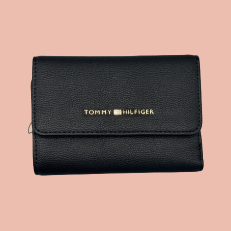Black Tommy Hilfiger wallet on a light gray background