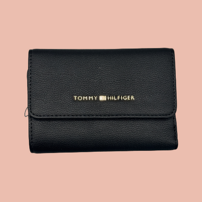 Black Tommy Hilfiger wallet on a light gray background