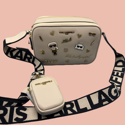 Beige handbag with decorative elements and Karl Lagerfeld strap on a gray background