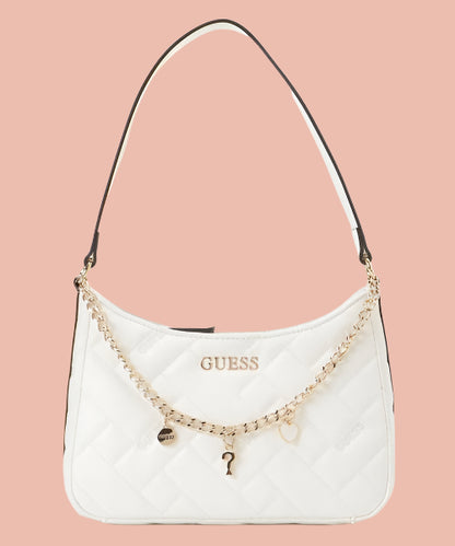 White handbag with gold chain and charms on a white background