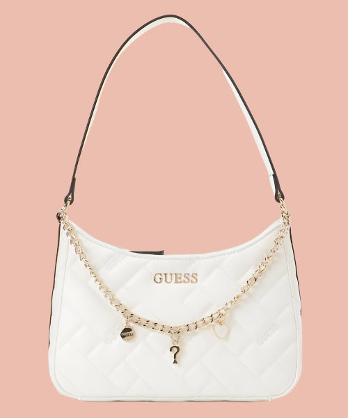 White handbag with gold chain and charms on a white background