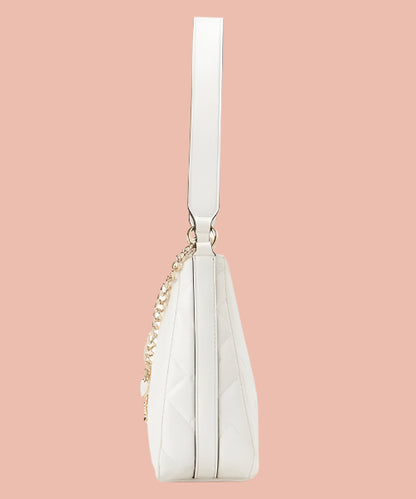 White handbag with a gold chain on a white background