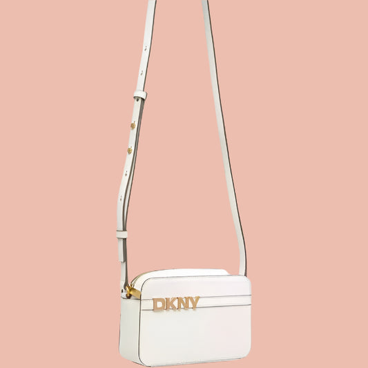 White crossbody bag with gold accents on a white background