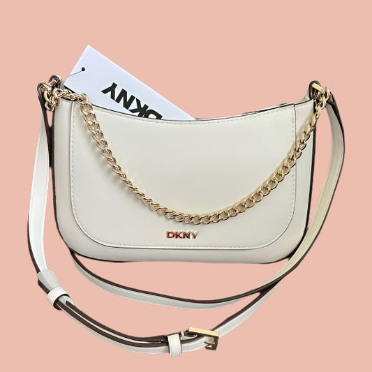 White handbag with gold chain detail and DKNY logo on a gray background