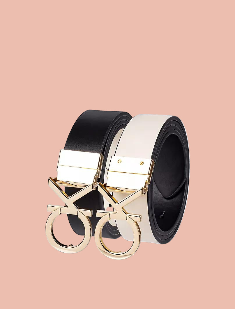 Black and white belt with gold buckle on a light gray background